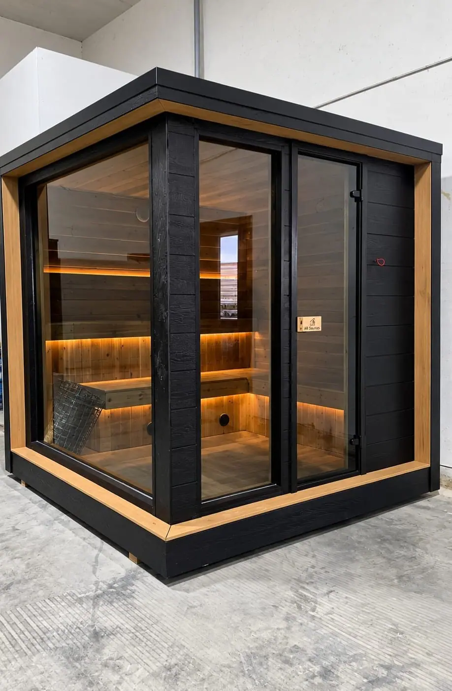 Black cube sauna with corner glass and cedar trim