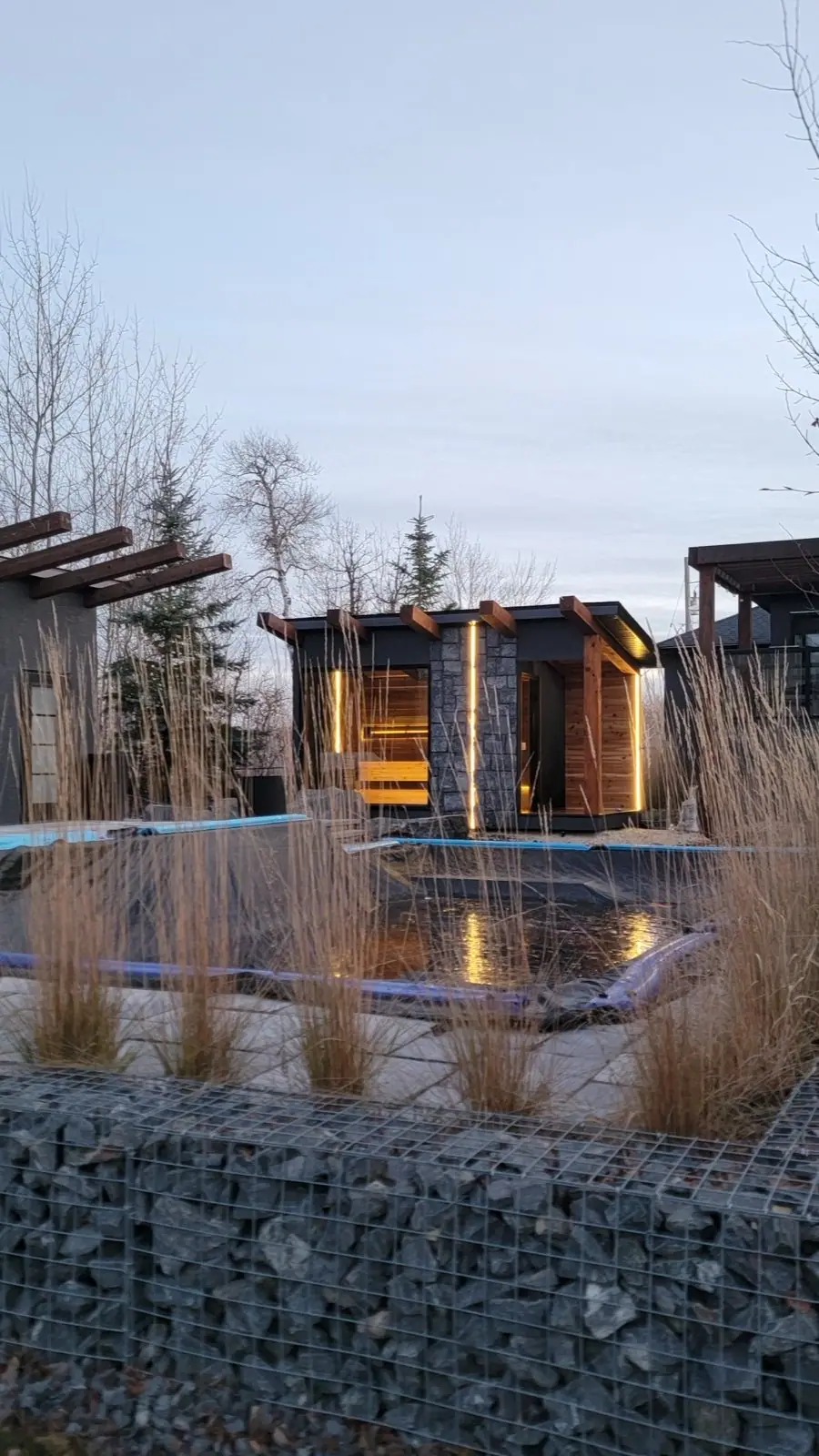 Sauna by a pond at dusk
