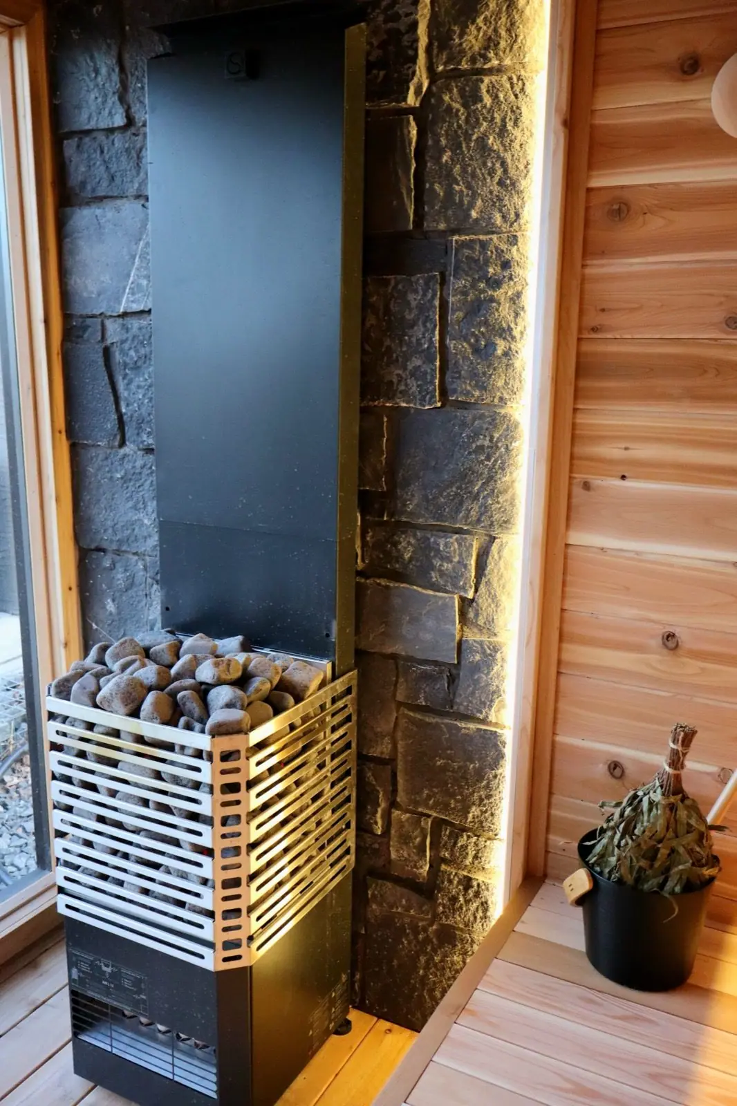 Custom sauna interior with stone wall and electric heater
