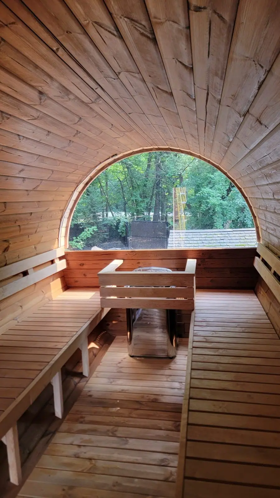Inside a barrel sauna with arched window