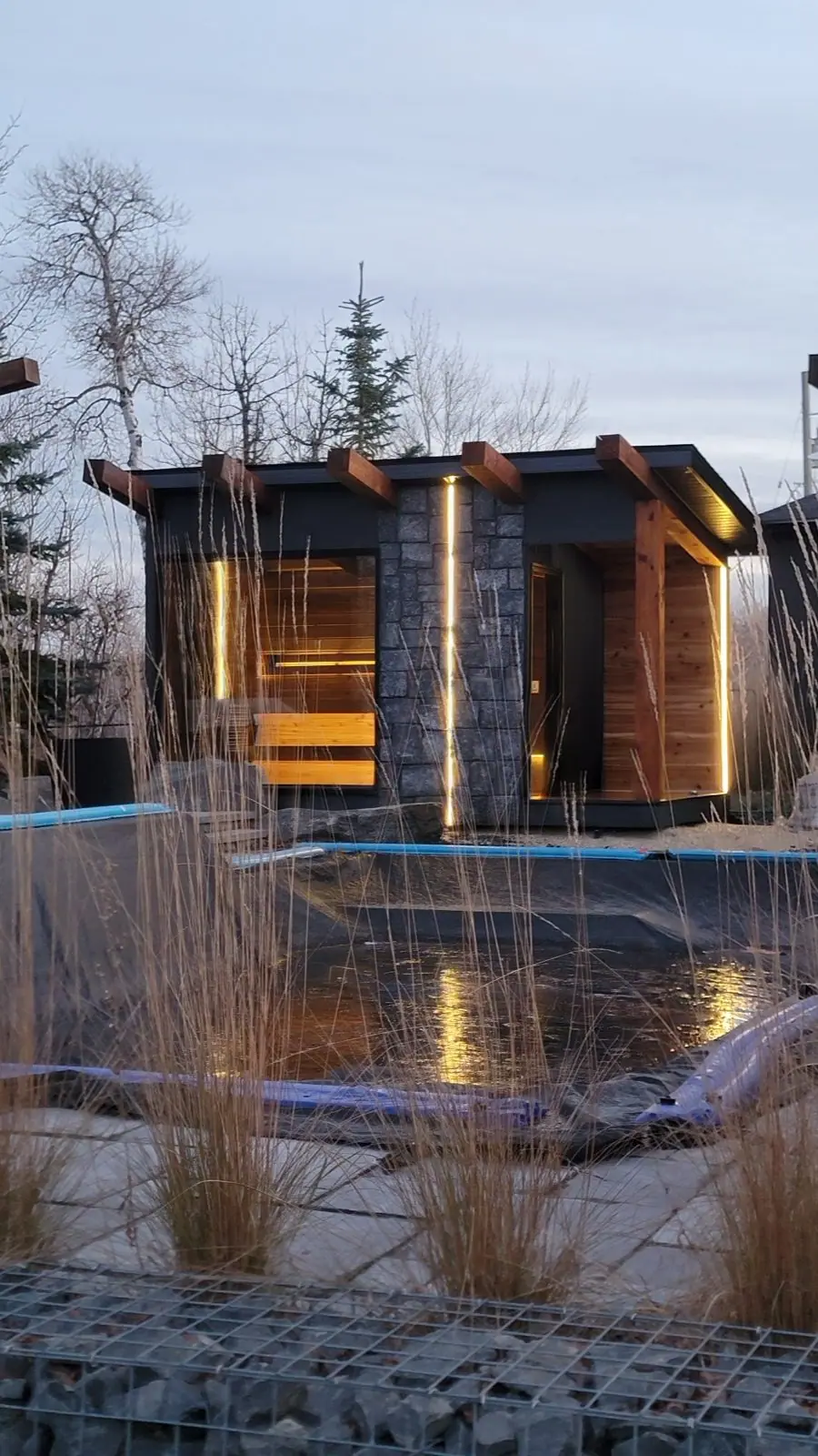 Pond-side sauna at dusk