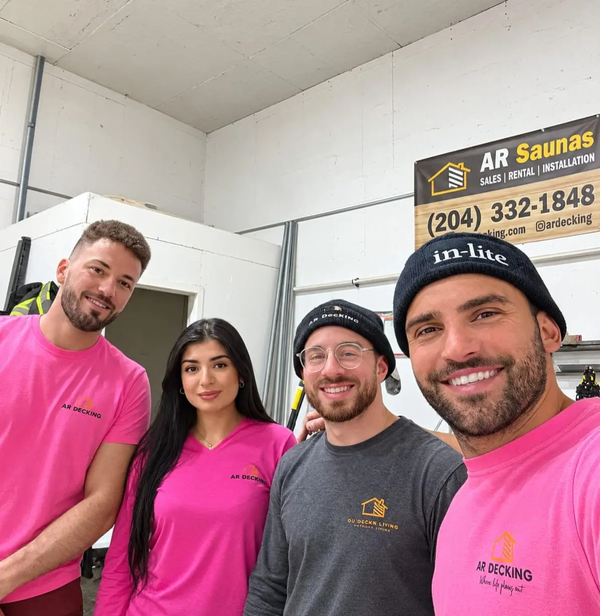 The team in the shop under the AR Saunas banner